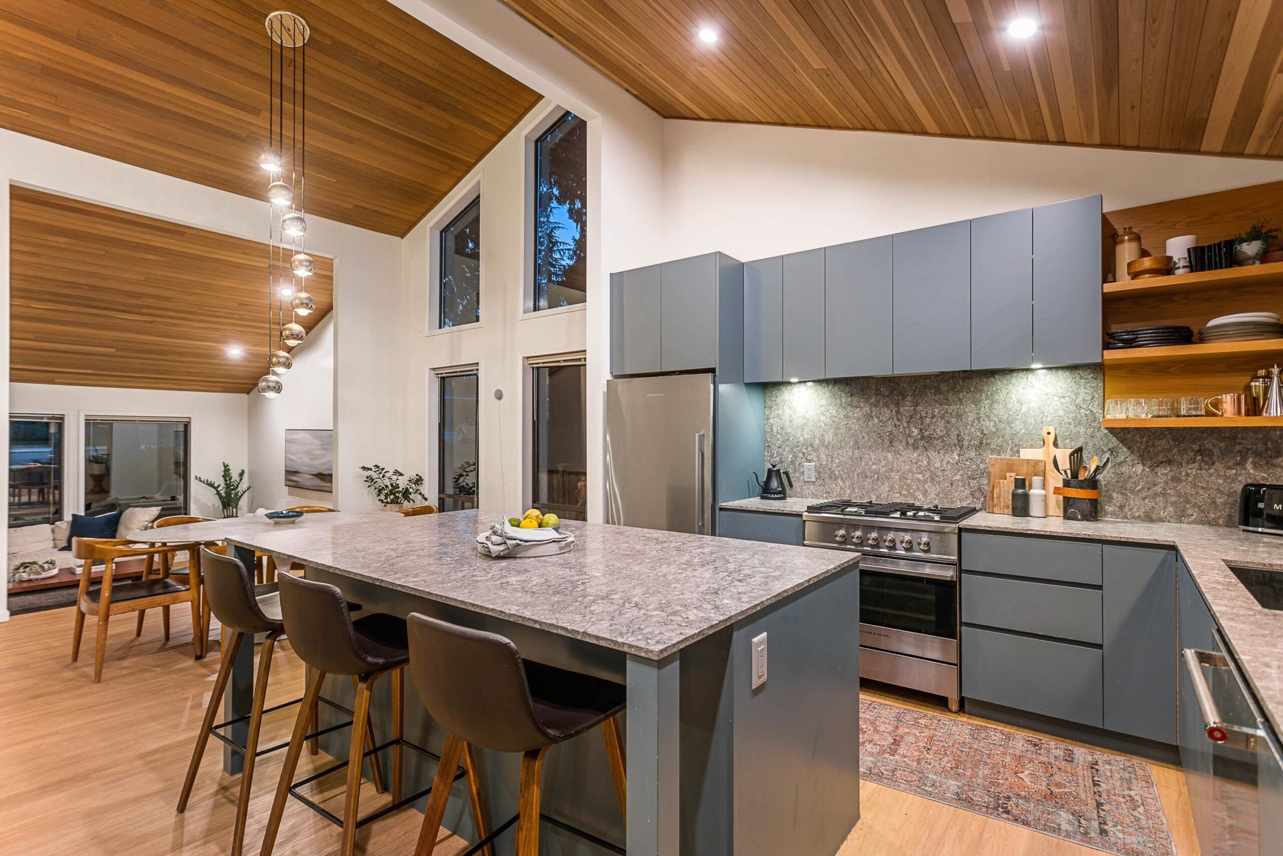 West Coast modern kitchen renovation featuring a cedar ceiling, warm wood tones, and clean contemporary cabinetry